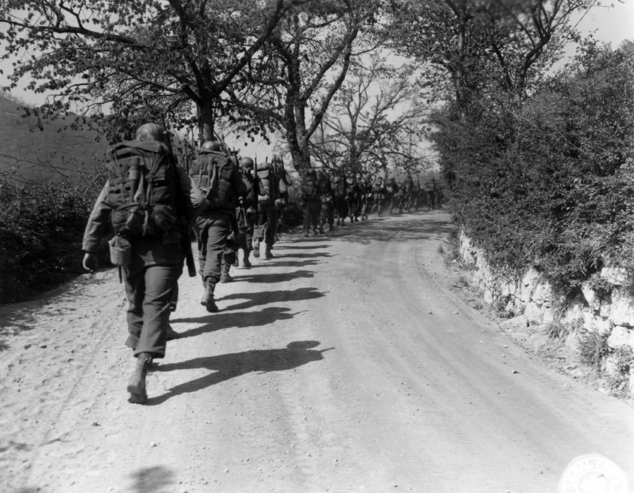 sc 270868   infantrymen of co. i  3rd bn.  85th regt.  10th mtn. div.  march in a column of file up the road to the trucks which will take them to more forward positions. 17 april .