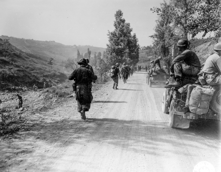 sc 270873   members of the 85th regt. th mtn. div.  moving up a dusty road to their new positions.