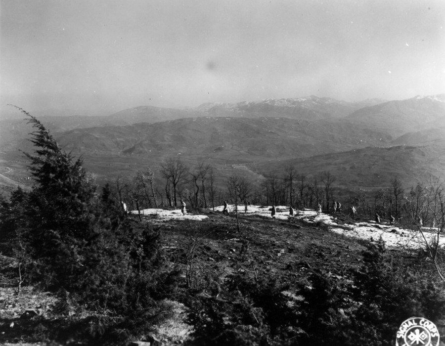 sc 374814   a white clad combat patrol of the 85th mtn. regt. th mtn. div.  cross snow patched ground near the crest of strategic mt. belvedere.